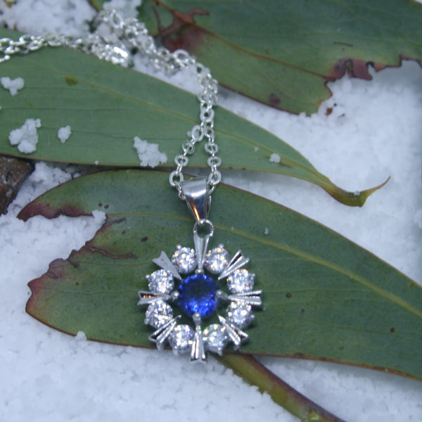 Sterling Silver Snowflake pendant w/- 1 Blue & White CZ's - SXP377